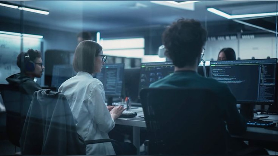 Managed IT team monitoring systems in a modern operations center